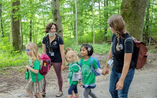 a group of people walking in the woods