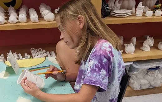 a girl painting on a table