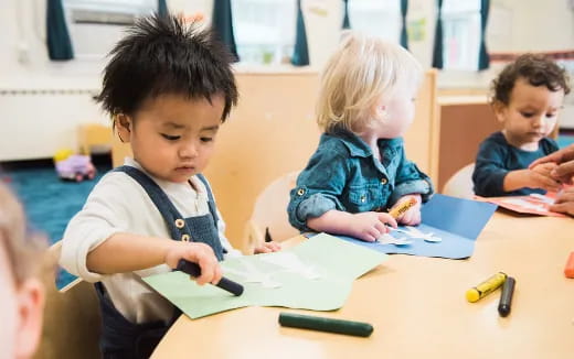a few children sitting at a table