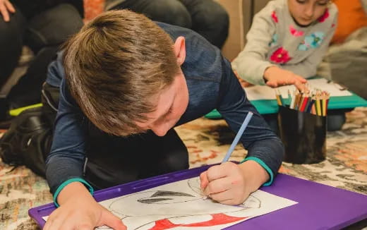 a person writing on a piece of paper