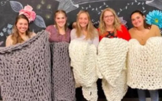 a group of women wearing white dresses