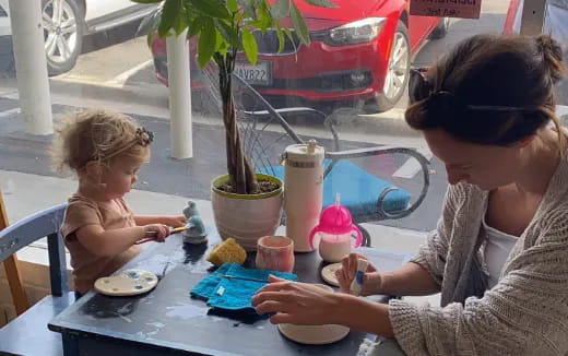 a woman and a child painting