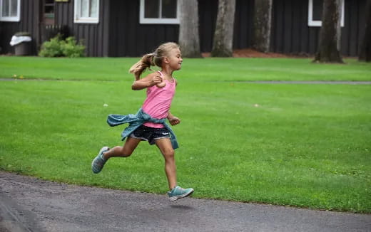 a girl running on grass