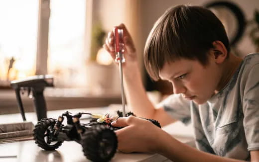 a young boy using a microscope