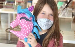 a girl holding a mask