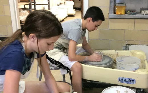 a man and a woman washing dishes