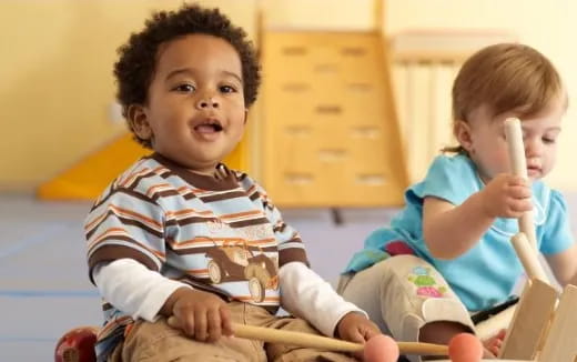 a couple of kids playing with a toy
