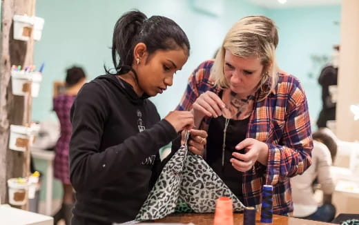 a man and woman looking at a tablet