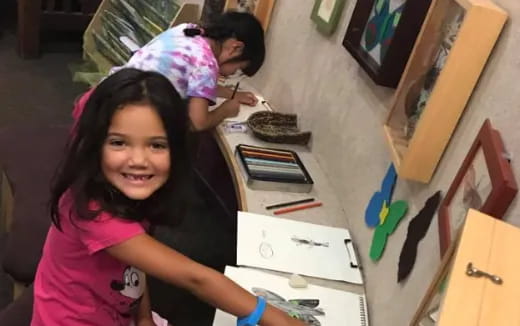 a girl smiling and painting