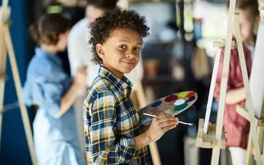 a young boy holding a toy