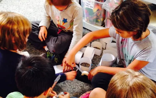 a group of children sitting around a table
