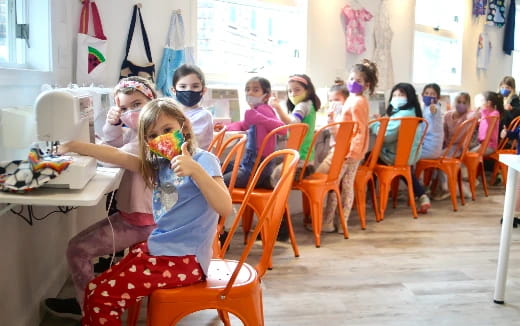 a group of children sitting in chairs