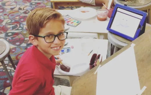 a boy sitting at a table