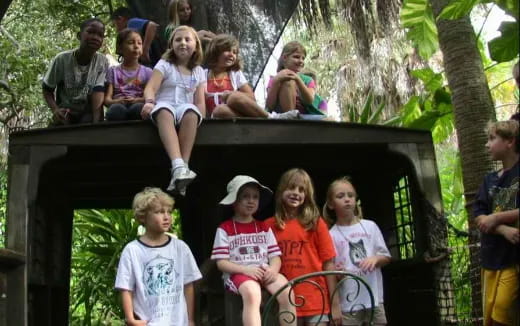 a group of children sitting on a bench