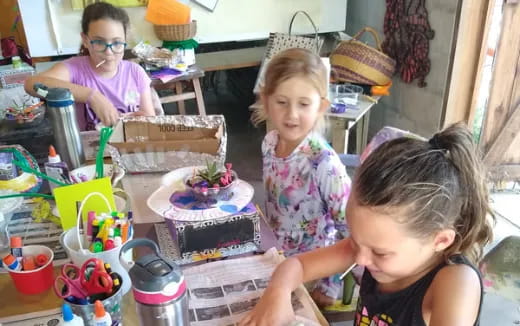 a group of people around a table with a cake