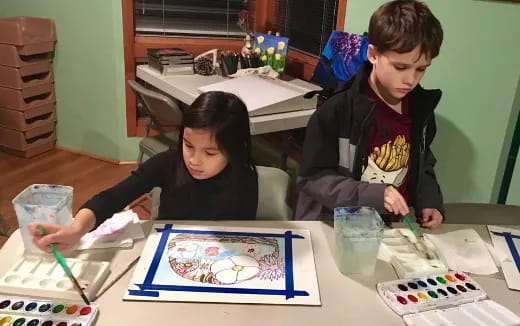 a boy and girl painting