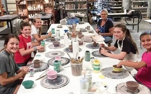 a group of people sitting around a table with food
