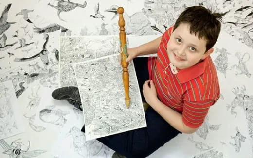 a boy holding a pencil