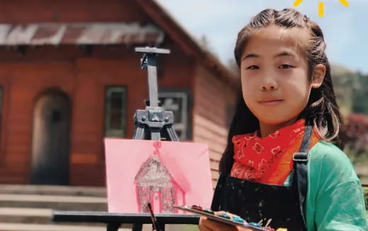 a girl standing in front of a camera