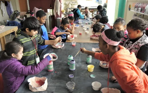 a group of children painting