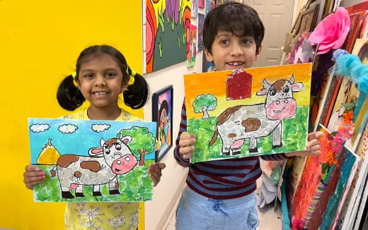 a couple of children holding books