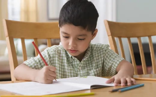 a child writing on a book