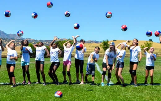 a group of people playing with balloons