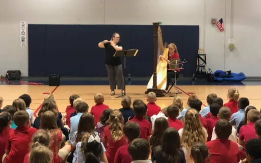 a man and woman on stage with a crowd watching