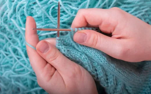 a person holding a needle