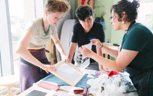 a group of women looking at a box