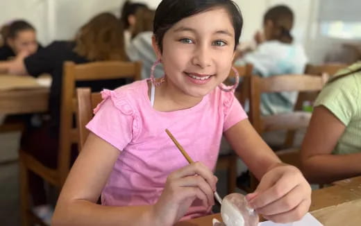 a girl holding a pencil