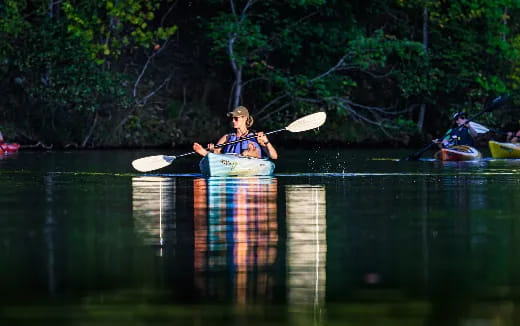 a man in a kayak in a lake