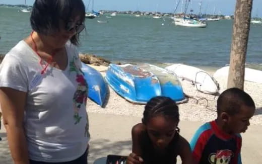 a person and two children on a beach