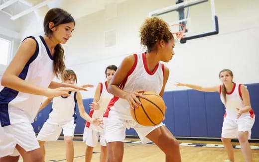 a group of women playing basketball