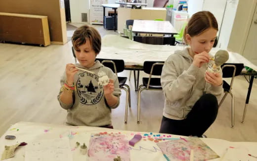 a couple of young girls painting