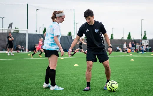 a man and a woman playing football