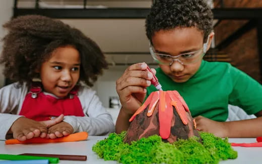 a young girl and a young boy painting
