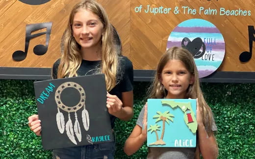 a person and a girl holding a sign