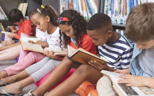 a group of children reading books
