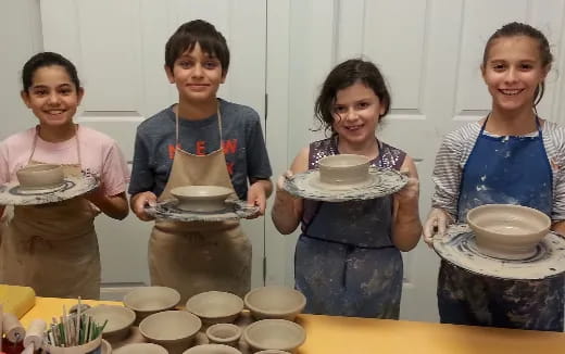 a group of women holding plates