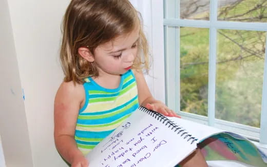 a girl holding a piece of paper