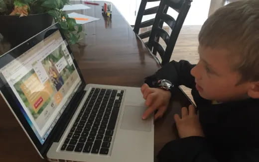 a boy using a laptop