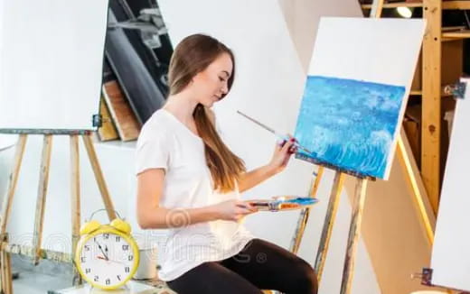 a woman painting a picture