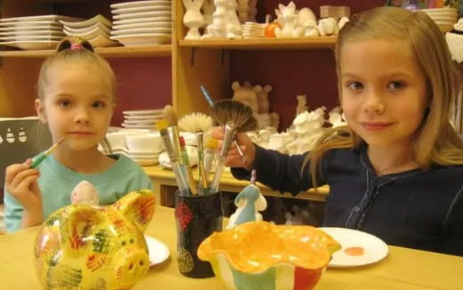 a couple of kids eating at a table