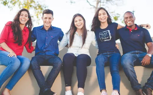 a group of people sitting together smiling