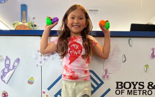 a girl holding toys