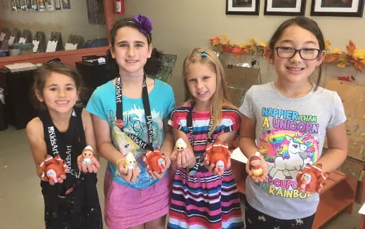 a group of girls holding toys