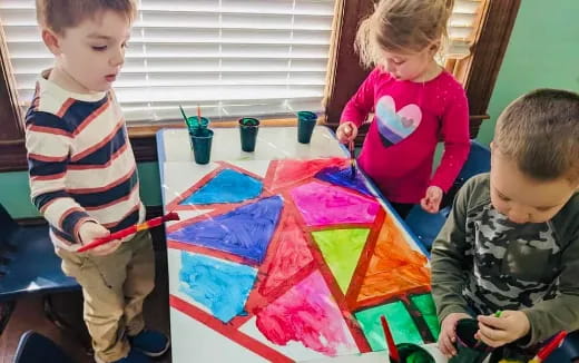 children painting on a table