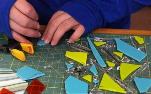 a person's hands on a colorful puzzle