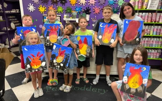 a group of children holding up books